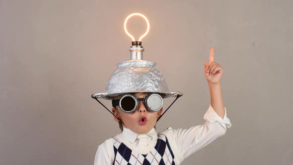 Funny child wearing handmade helmet with lightbulb. Slow motion