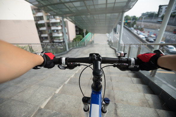 Riding bike going down the stairs of overpass Stock Photo by lzf | PhotoDune