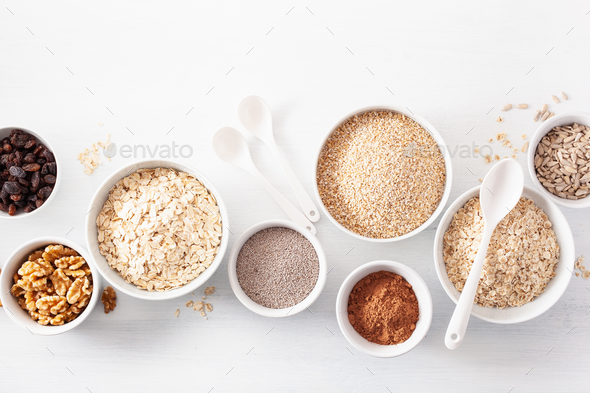 variaty of raw cereals and nuts for breakfast. Oatmeal flakes an - Stock Photo - Images