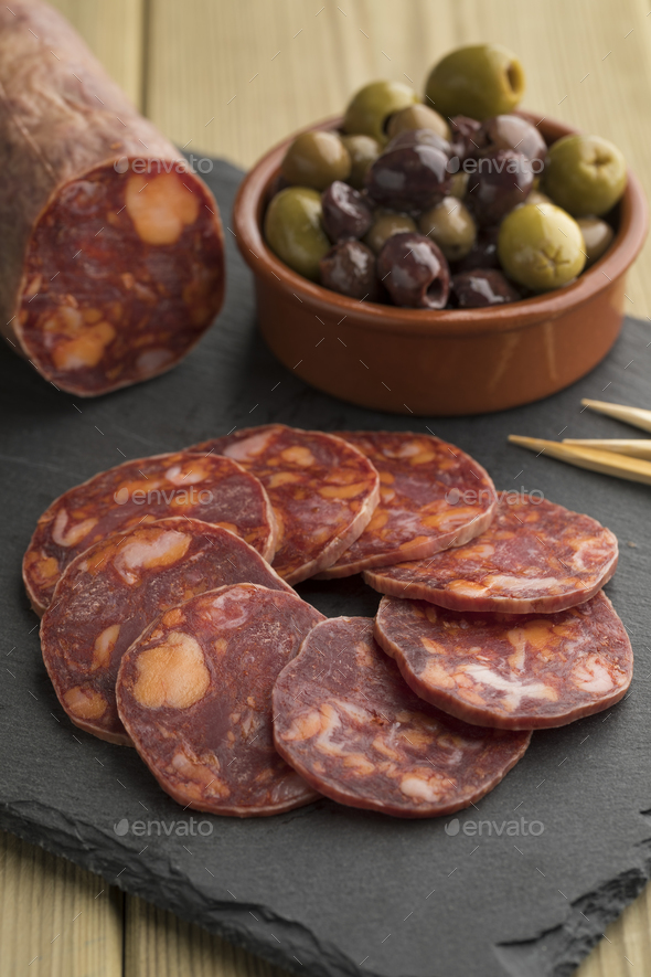 Traditional piece of Spanish chorizo sausage Stock Photo by picturepartners