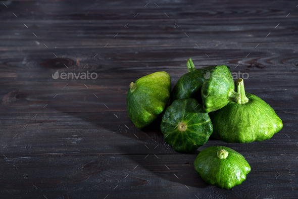 small size patty pan patisson squash on dark wooden background with copy space Stock Photo by lyulkamazur