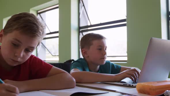 Boy using laptop in the class alt