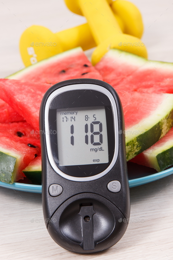 Watermelon, glucometer with result sugar level and dumbbells, healthy lifestyles concept Stock Photo by ratmaner