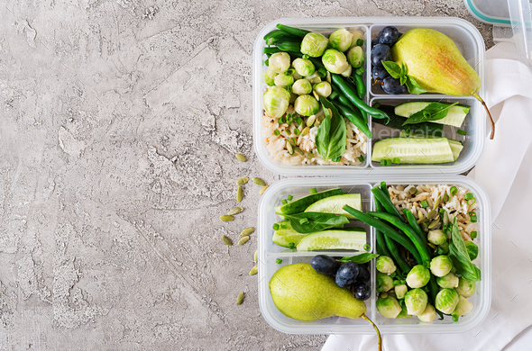 Vegan green meal prep containers with rice, green beans, brussel sprouts, cucumber and fruits Stock Photo by Timolina