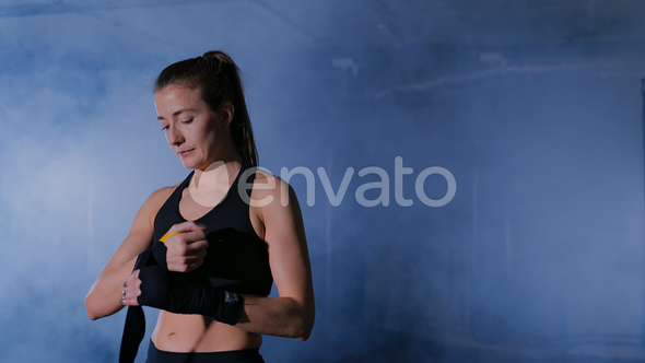 Woman Completing Wrapping of Her Hand for Boxing alt