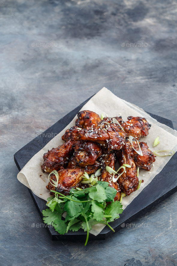 Sticky chicken wings with sesame, spicy sauce, copy space