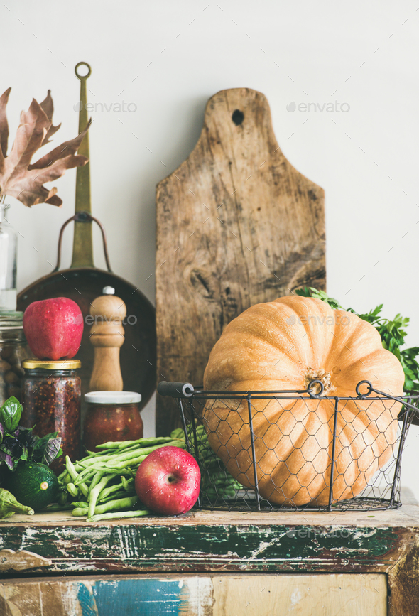 Autumn food ingredients and utensils over cupboard chest, vertical composition Stock Photo by sonyakamoz