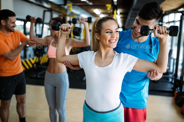 Personal trainer giving instructions in gym Stock Photo by nd3000 | PhotoDune