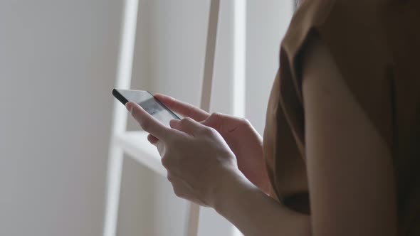 Close up hands young Asian businesswoman holding typing mobile phone.