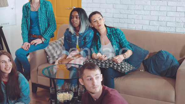 Company of Friends Is Sitting and Watching TV, at This Time a Friend Brings Pizza and Treats alt