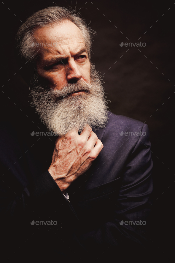 mature male model wearing suit with grey hairstyle and beard Stock Photo by  zdenkadarula