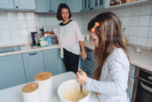 happy family cook together in the kitchen Stock Photo by simbiothy