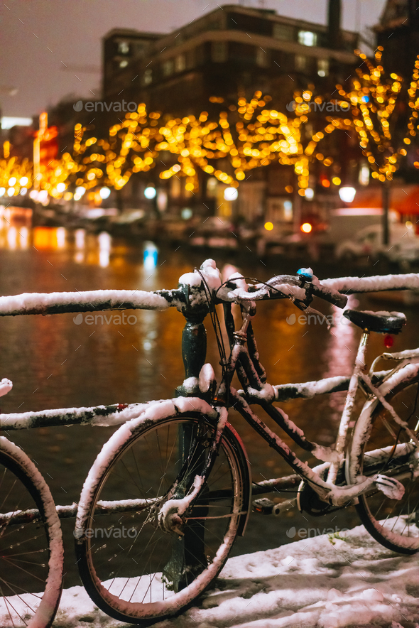Bicycles Parked Along a Bridge Over the Canals of Amsterdam Stock Photo by simbiothy
