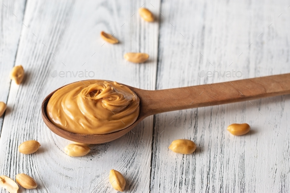Wooden spoon of peanut butter Stock Photo by Alex9500