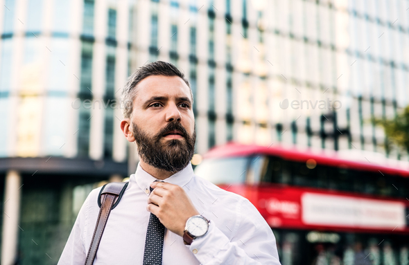 Hipster businessman standing on the street in London. Copy space. Stock Photo by halfpoint