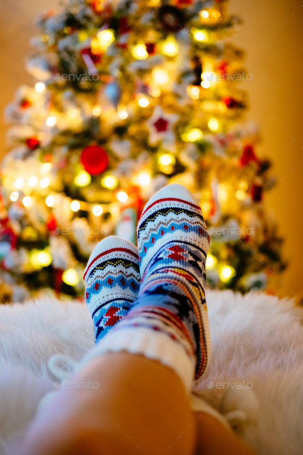 Relaxing in front of Christmas tree Stock Photo by Determined PhotoDune