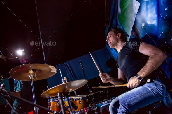 Drummer playing on drum set on stage. Stock Photo by cookelma | PhotoDune