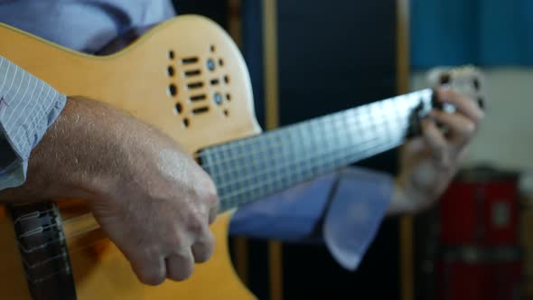 Hand of Male Musician Playing on Acoustic Guitar