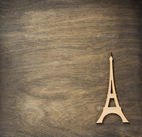 eiffel tower toy at plywood background surface Stock Photo by seregam