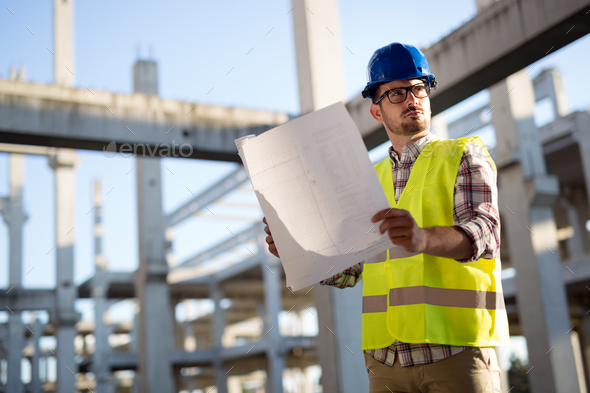 Picture of construction site engineer looking at plan Stock Photo by nd3000