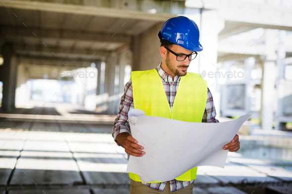 Picture of construction site engineer looking at plan Stock Photo by nd3000