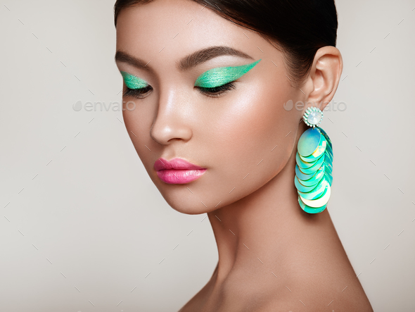 Beautiful Korean Woman with large turquoise earrings - Stock Photo - Images
