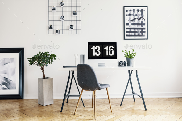 Real photo of a modern home office interior with a desk, chair, Stock Photo by bialasiewicz