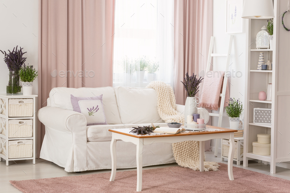 Real photo of bright provencal sitting room interior with white Stock Photo by bialasiewicz