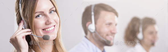 Woman with headphones working in call centre - Stock Photo - Images
