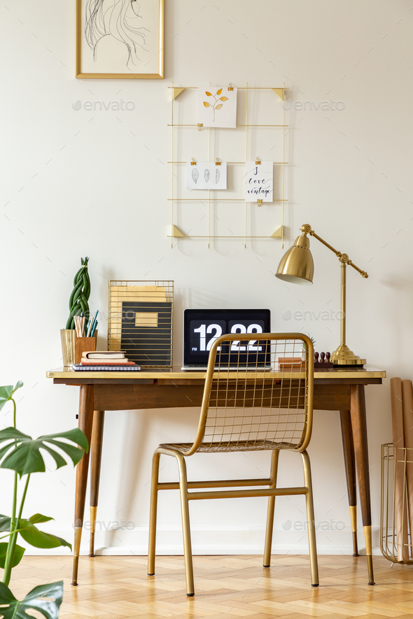 Gold chair at desk with laptop and lamp in classic freelancer\'s Stock Photo by bialasiewicz