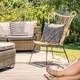 Woman reading a book on patio with rattan table, chair and sofa - $5.00 Woman reading a book on patio with rattan table, chair and sofa