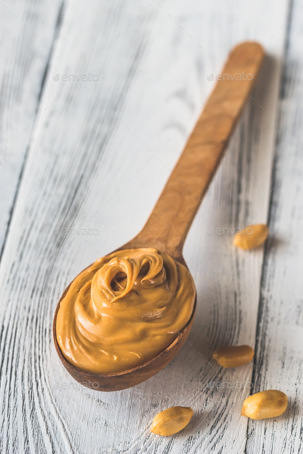 Wooden spoon of peanut butter Stock Photo by Alex9500