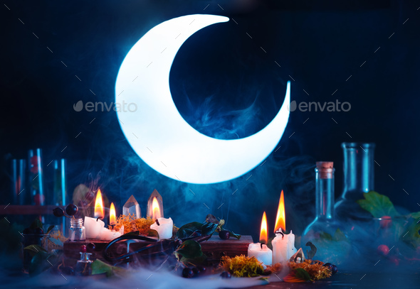Halloween header with shining full Moon. Witch or wizard workplace with burning candles. Spooky - Stock Photo - Images