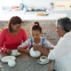 Happy multi-generation family having tea in dining table - $5.00 Happy multi-generation family having tea in dining table