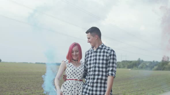 Happy Couple Showing Smoke Heart in Countryside alt