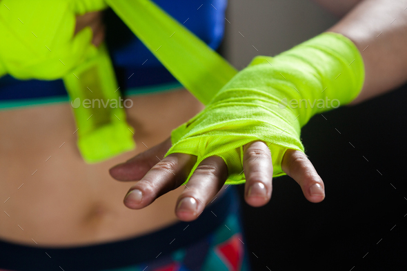 Mid section of woman tying hand wrap on hand - Stock Photo - Images