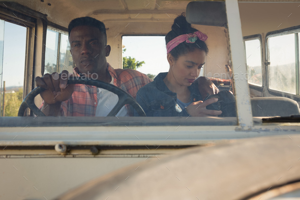 Couple sitting in car at countryside - Stock Photo - Images