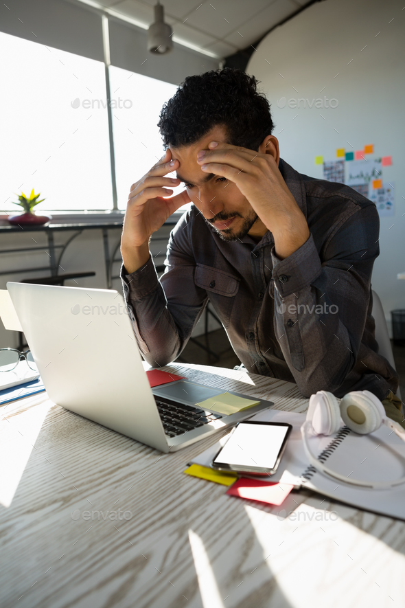 Frustrated businessman at office - Stock Photo - Images