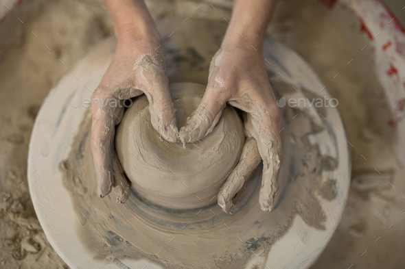 Close-up of female potter molding clay Stock Photo by Wavebreakmedia