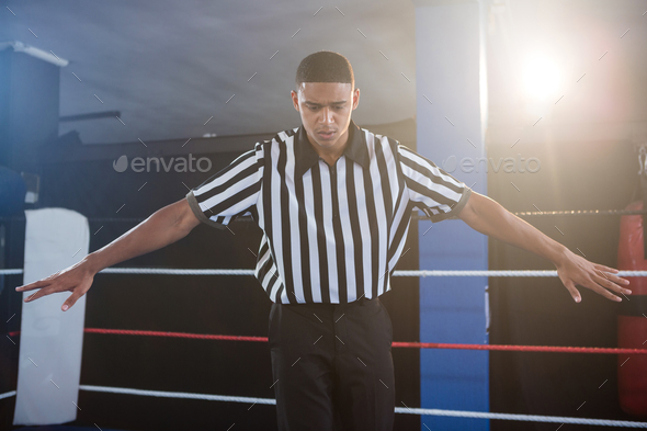Male referee gesturing with arms outstretched - Stock Photo - Images