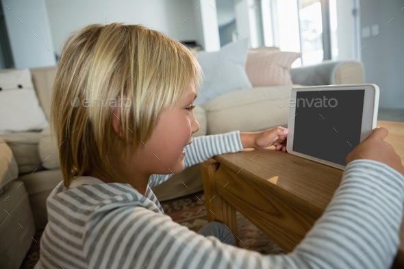 Boy using digital tablet in the living room Boy using digital tablet in the living room