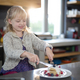 Little girl cutting a fruit pancake with a fork and knife - $5.00 Little girl cutting a fruit pancake with a fork and knife
