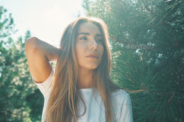 Close-up young woman with beautiful face features enjoying sun - Stock Photo - Images