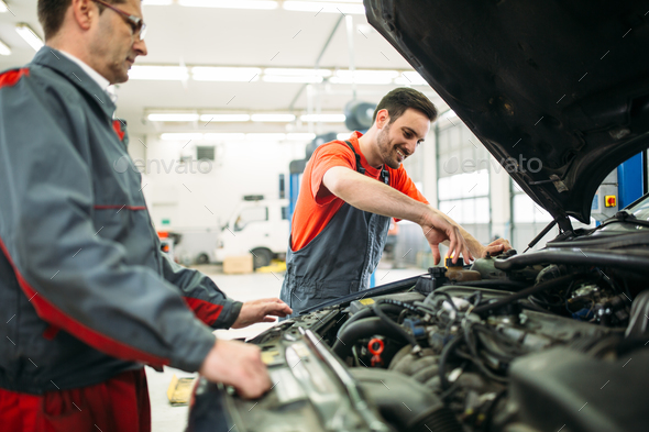 Car mechanics working at automotive service center Stock Photo by nd3000