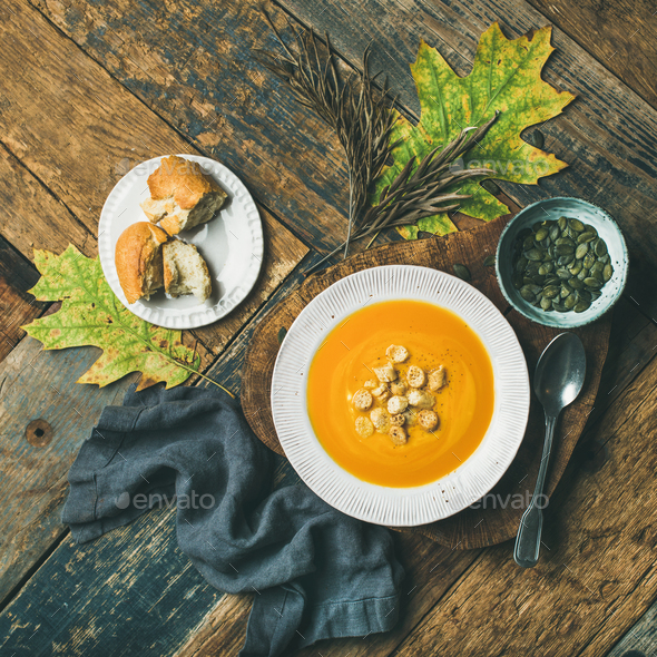 Warming pumpkin cream soup with croutons and seeds, square crop - Stock Photo - Images