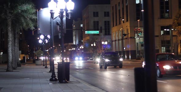 Cars Driving Down City Street At Night