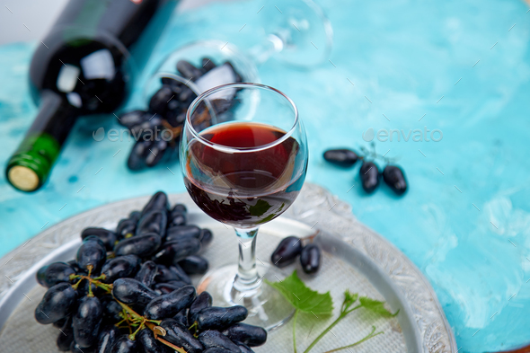 Red wine concept with bottle, glass and grapes - Stock Photo - Images