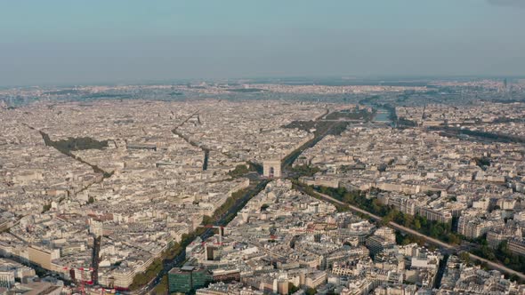 Wide circling drone shot of the Arc de Triomphe Paris golden hour sunset alt