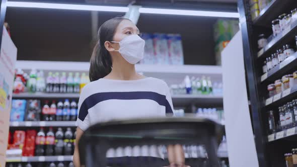 young adult asian female woman wearing protective face mask hand choosing fresh product