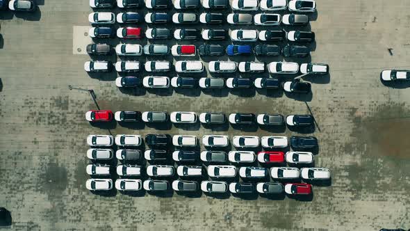Plenty of New Cars Located at the Factory Parking Lot Filmed From Above alt